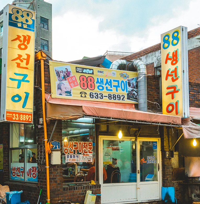 파란 현수막 간판이 걸린 노포 88생선구이 식당의 정겨운 거리 외관