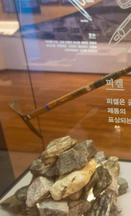 유리 진열장 안에 전시된 피켈과 등반용 돌무더기 등 등산용품의 모습