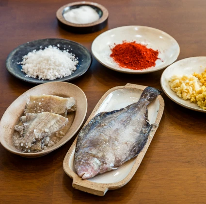 손질한 가자미와 굵은소금, 고춧가루, 좁쌀밥 등 가자미식해를 담그는 데 쓰이는 재료들이 그릇에 나뉘어 놓인 상차림